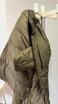 Vertical 4K footage showcasing a solitary vest hanging on a hanger in a doctor's waiting room, evoking a sense of anticipation and solitude.