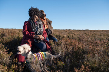 Two senior women with dog in moorland