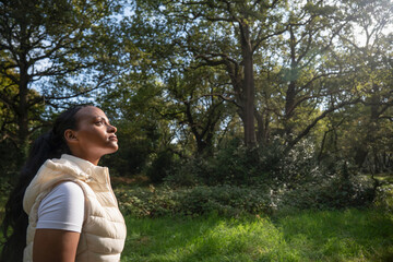 Portrait of young woman relaxing in park on sunny day