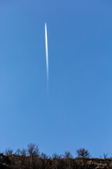 Roccamorice, Italy A plane with a contrail flies over the Majella mountains