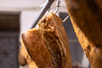 Goriano Sicoli, Italy Fresh proscuitto ham hanging for curing.