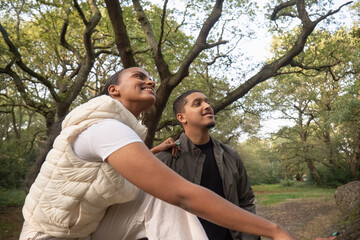 Portrait of smiling couple sitting under tree