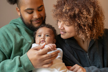 Parents sitting with baby daughter at home