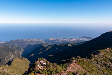 Mountain cottage Casa de Abrigo along scenic hiking trail to peak mount Pico Ruivo, Madeira island, Portugal, Europe. Panoramic coastline view of majestic Atlantic Ocean. Wanderlust subtropical nature