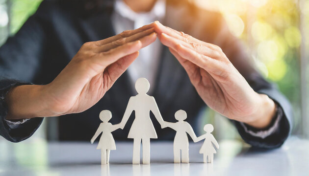 Businesswoman's hand shields family figures on white table, symbolizing protection and care
