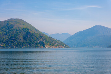Fototapeta na wymiar Alpine Lake Lugano with Mountain in a Sunny Day in Morcote, Ticino, Switzerland.