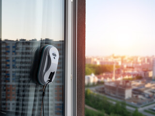 Vacuum cleaner washing windows. Home appliance concept
