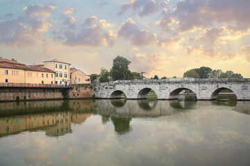 Historical roman Tiberius Bridge over Marecchia river in Rimini, Italy	
