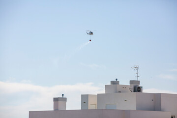 Fototapeta na wymiar firefighting helicopter hydrating a fire