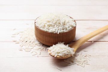 Uncooked raw basmati rice on white wooden table