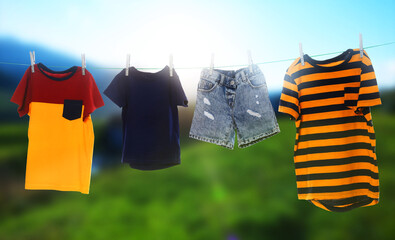 Different clothes drying on washing line outdoors, banner design