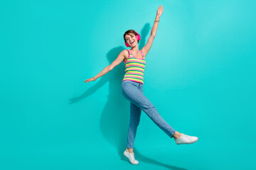 Fototapeta na wymiar Full length portrait of cheerful nice person have good mood dancing isolated on cyan color background