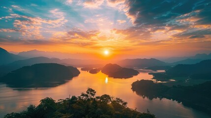 Amazing landscape with mountains and lake during sunset. The sky is ablaze with color, and the water reflects the vibrant hues. - obrazy, fototapety, plakaty
