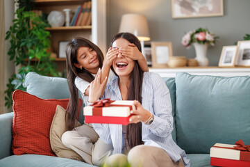 Daughter presents mother with Mother's Day gift - 747347634