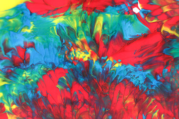 Abstract background of acrylic paint in blue, red and yellow tones.