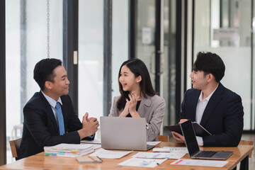 Group of young smart business people brainstorming on the project together in the modern office room.