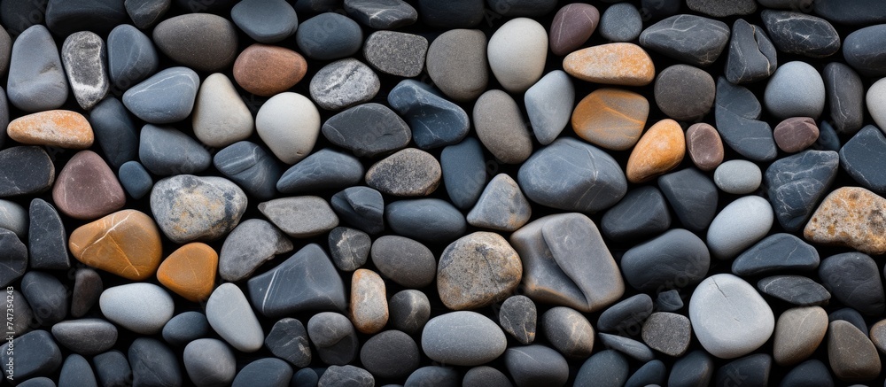 Poster A collection of rocks lined up closely next to each other form an abstract texture, showing the complexity of wall cladding design using smooth stones.