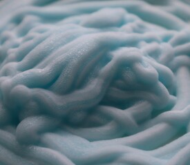 Close-up of squeezed  out cream. A pile of squeezed blue cream. Many  squeezed cream