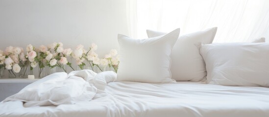 A white bed adorned with crisp white pillows and white sheets, creating a clean and minimalist look in a bedroom setting. The soft pillows contrast beautifully against the pristine white bedding.