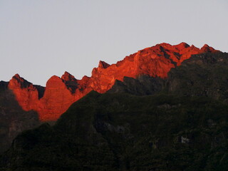 Red light of sunset over the Piton des neiges mountain summit from Cilaos, Reunion island. La...