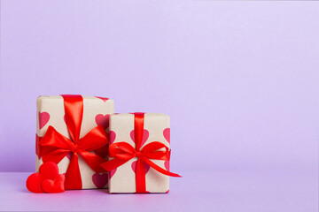 Valentine day composition: sweet candy, with gift boxes with bow and red felt hearts, photo...