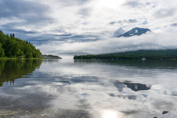 A foggy morning on Lake Clark in Alaska. Port Alsworth and Hardenburg Bay in Lake Clark National Park and Preserve. Inverted cloud layer, inversion layer, low visibility.