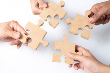 The hands that are helping each other assemble the jigsaw puzzle, Business connection concept