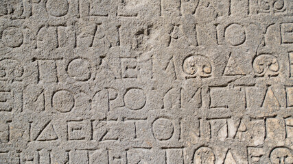Close-up  background of ancient Greek writings on the ruins of an ancient city