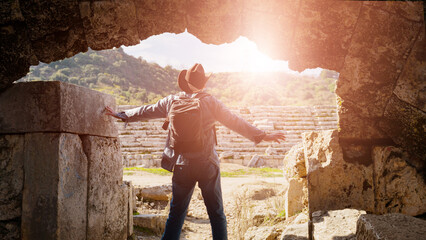 An archaeologist traveler is a tourist on the background of ancient ruins