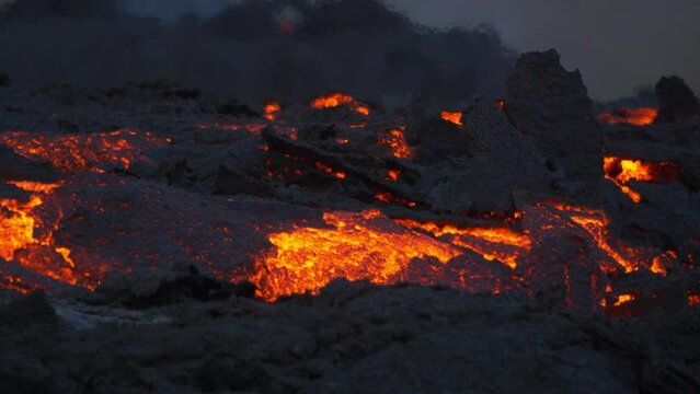 Close up view of hot lava flowing from the crater. Volcanic rocks. Red lava river.