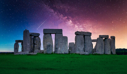 Landscape image of Milky way galaxy at night sky with stars over Stonehenge an ancient prehistoric stone monument, Wiltshire, UK.