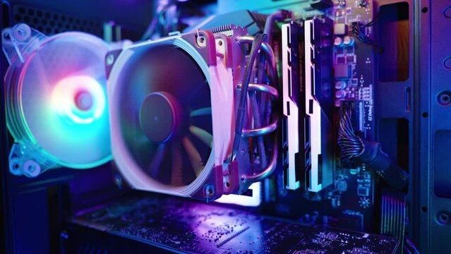 Interior of a gaming desktop PC with rainbow lighting on the RAM heatsink. Close-up.