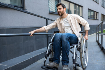 Disabled man on a wheelchair looking positive and smiling