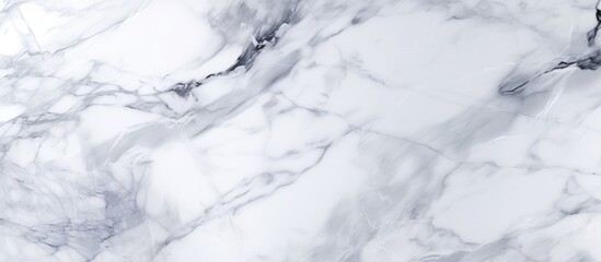 Fototapeta premium Detailed view of a white marble texture background, showcasing the intricate patterns and veins characteristic of marble. The smooth surface and unique markings create a visually interesting backdrop.