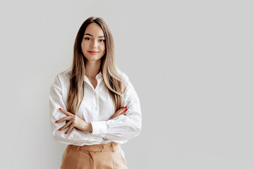 Portrait of a Caucasian business lady in a white shirt with folded hands - obrazy, fototapety, plakaty