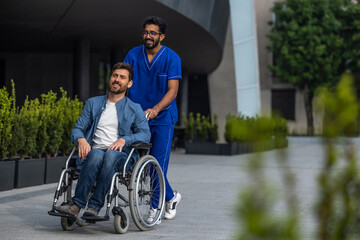 Brunette man in doctors overall carrying a wheelchair with a patient
