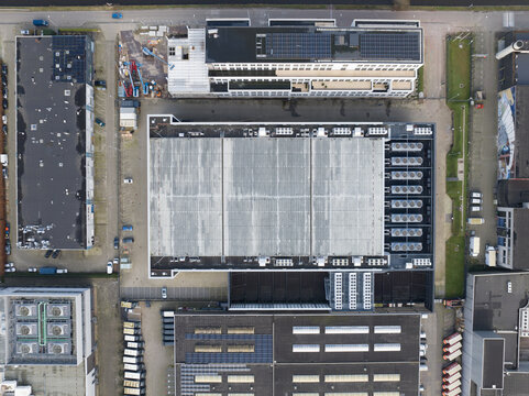 Aerial top down drone view on a data center and cooling vans build in the roof.