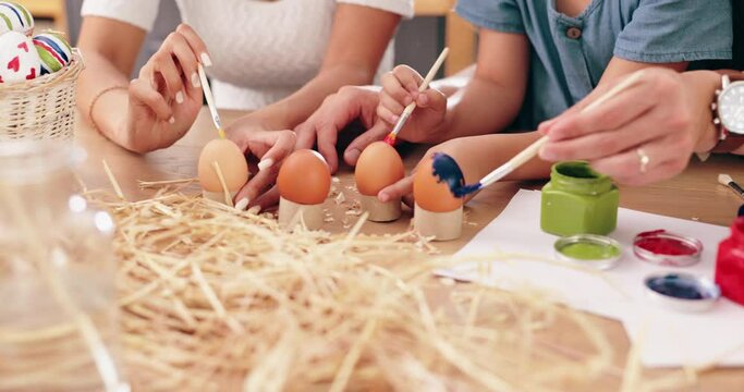 Easter, painting and parents with children and eggs for holiday, festival celebration and decoration. Family, home and hands with paintbrush for creative activity, learning and bonding for tradition