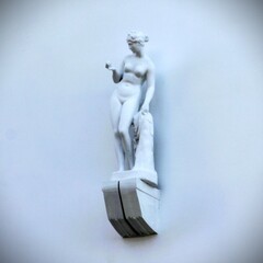 Sculpted statue of a lady on the wall