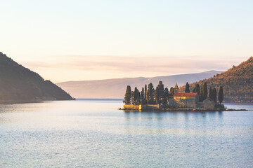 Fototapeta premium Saint George Island (Ostrvo Sveti Dorde) at sunrise. One of the two islets off the coast of Perast in Bay of Kotor, Montenegro