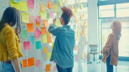 Creative marketing team brainstorming session: diverse group writing ideas on sticky notes