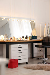 Makeup room. Stylish dressing table with mirror and chair