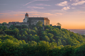 Ancient castle in summer forest colors.