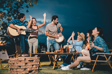 summer party camping of friends group with guitar music, happy young woman and smiling man having...
