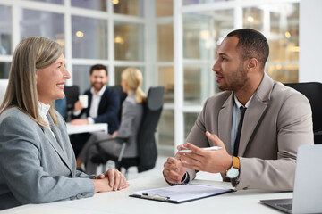 Lawyers working together at table in office, selective focus