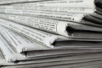 Stack of newspapers as background, closeup. Journalist's work