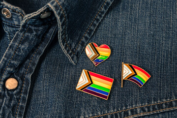 three pins with the LGTBI rainbow flag flag