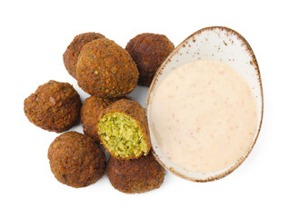 Delicious falafel balls and sauce isolated on white, top view
