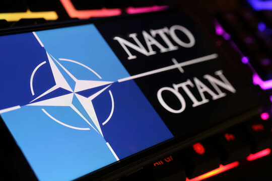 Viersen, Germany - January 9. 2024: Smartphone screen with logo lettering of NATO OTAN on computer keyboard
