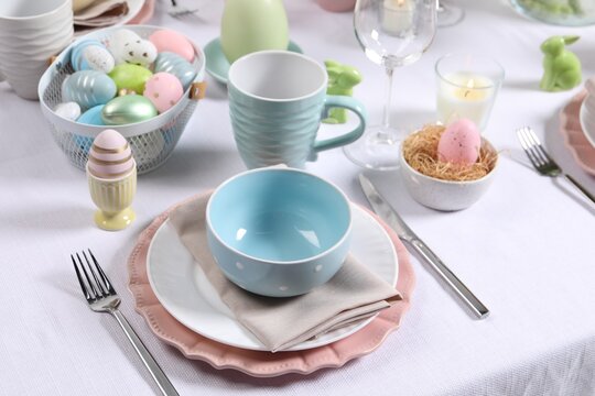Festive table setting with painted eggs. Easter celebration